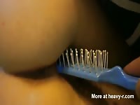 Insane pussy insertion movie features a young apple bottomed babe taking a hairbrush deep