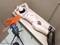A crossdresser being whipped by a large electric fan
